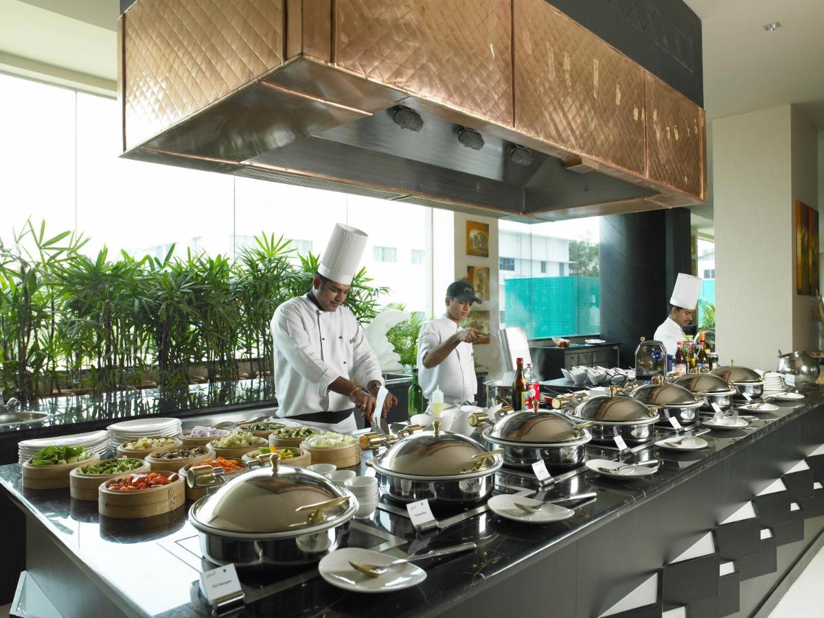 a group of chefs in a kitchen preparing food at The Zuri Whitefield Bengaluru in Bengaluru
