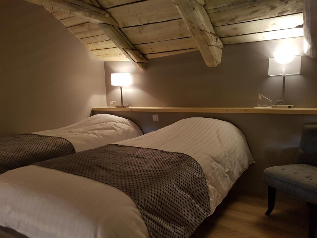 Un ou plusieurs lits dans un hébergement de l'établissement Logis SPA Hotel Restaurant De La Poste