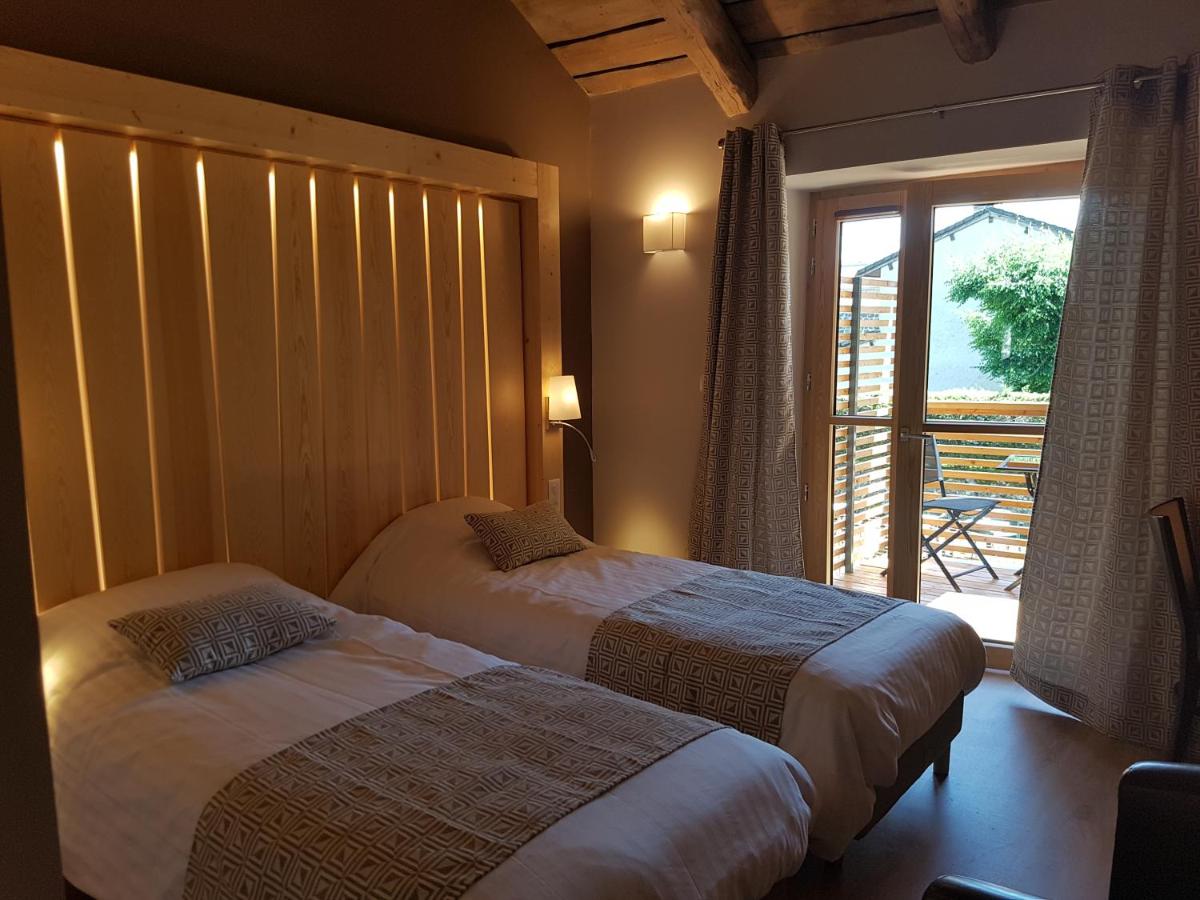 Un ou plusieurs lits dans un hébergement de l'établissement Logis SPA Hotel Restaurant De La Poste