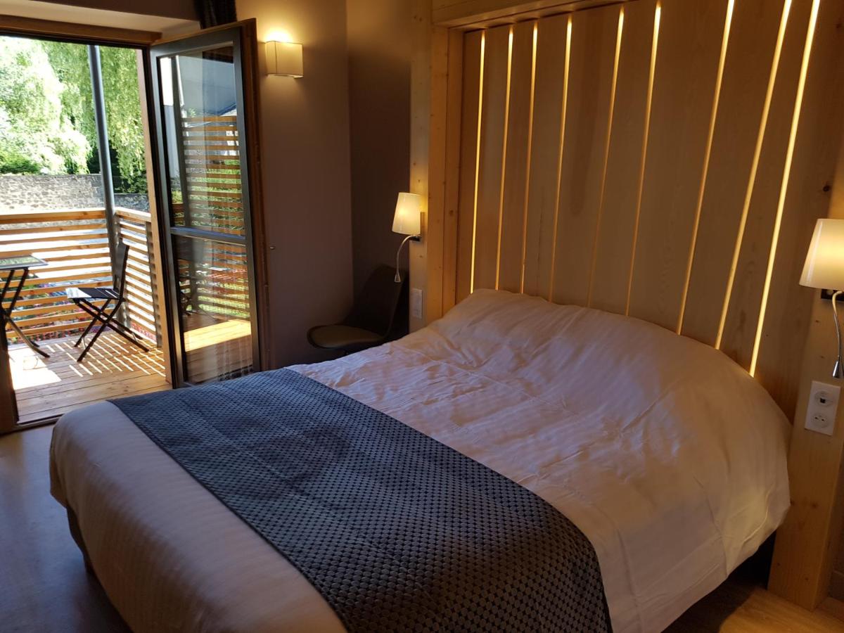 Un ou plusieurs lits dans un hébergement de l'établissement Logis SPA Hotel Restaurant De La Poste