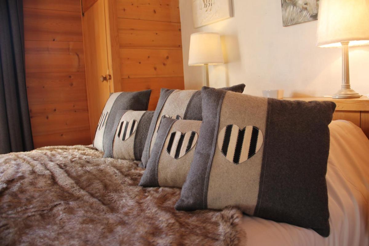Un ou plusieurs lits dans un hébergement de l'établissement Les Chalets de La Griyotire
