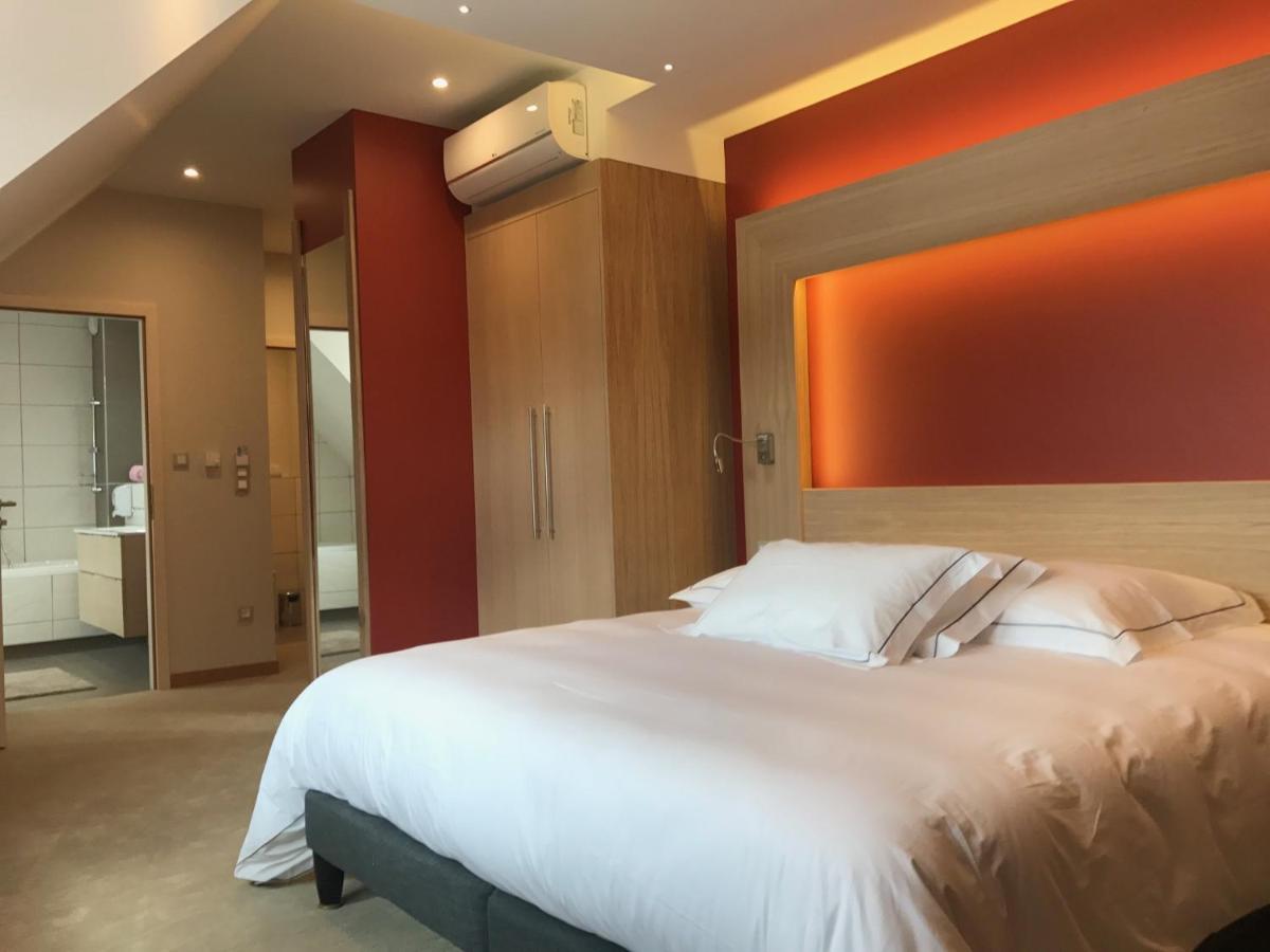 Un ou plusieurs lits dans un hébergement de l'établissement Au Soleil, Hôtel Restaurant & Spa