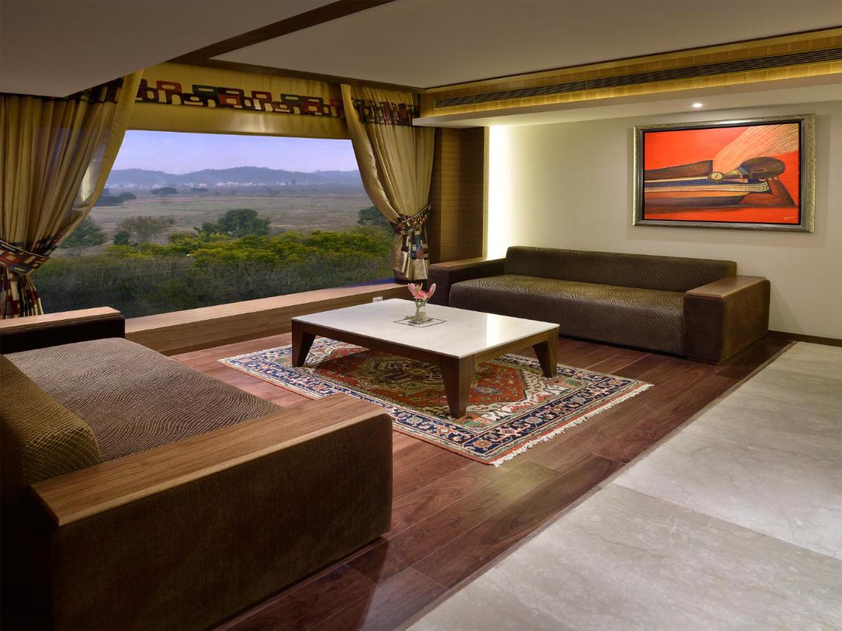 a living room with a couch and a table at The Lalit Chandigarh in Chandīgarh
