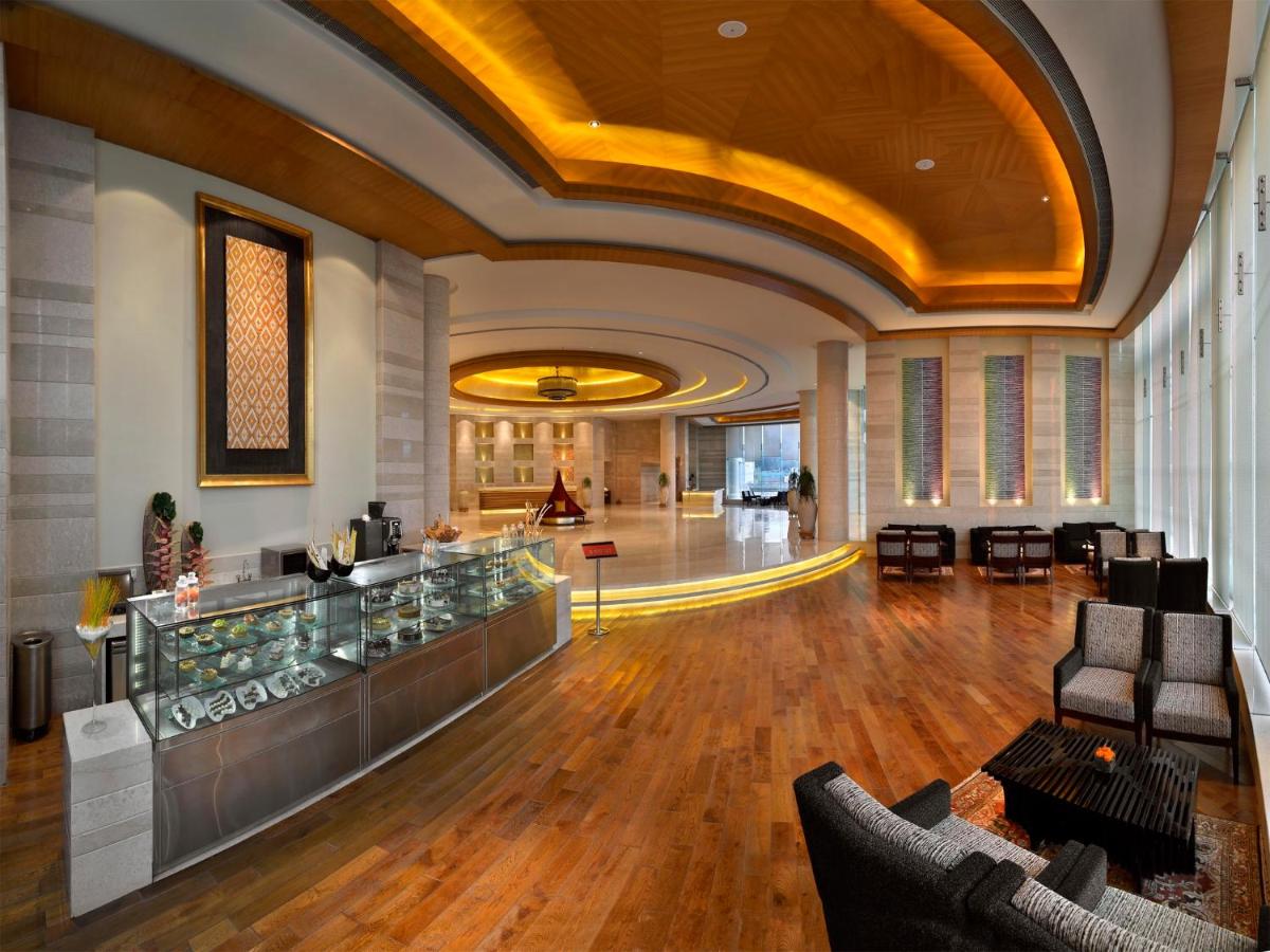 a lobby with a bar in a building at The Lalit Chandigarh in Chandīgarh