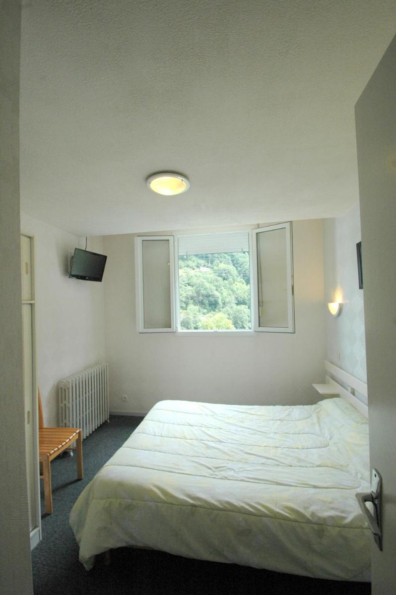 Un ou plusieurs lits dans un hébergement de l'établissement Appart Le Chili- Quartier thermal- Parc remarquable - Linge fourni