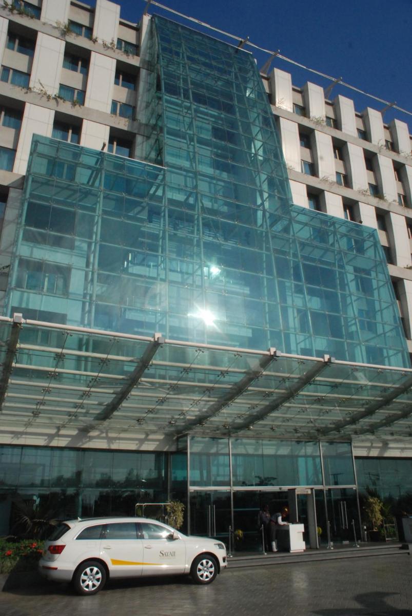 a car parked in front of a glass building at Sayaji Pune in Pune