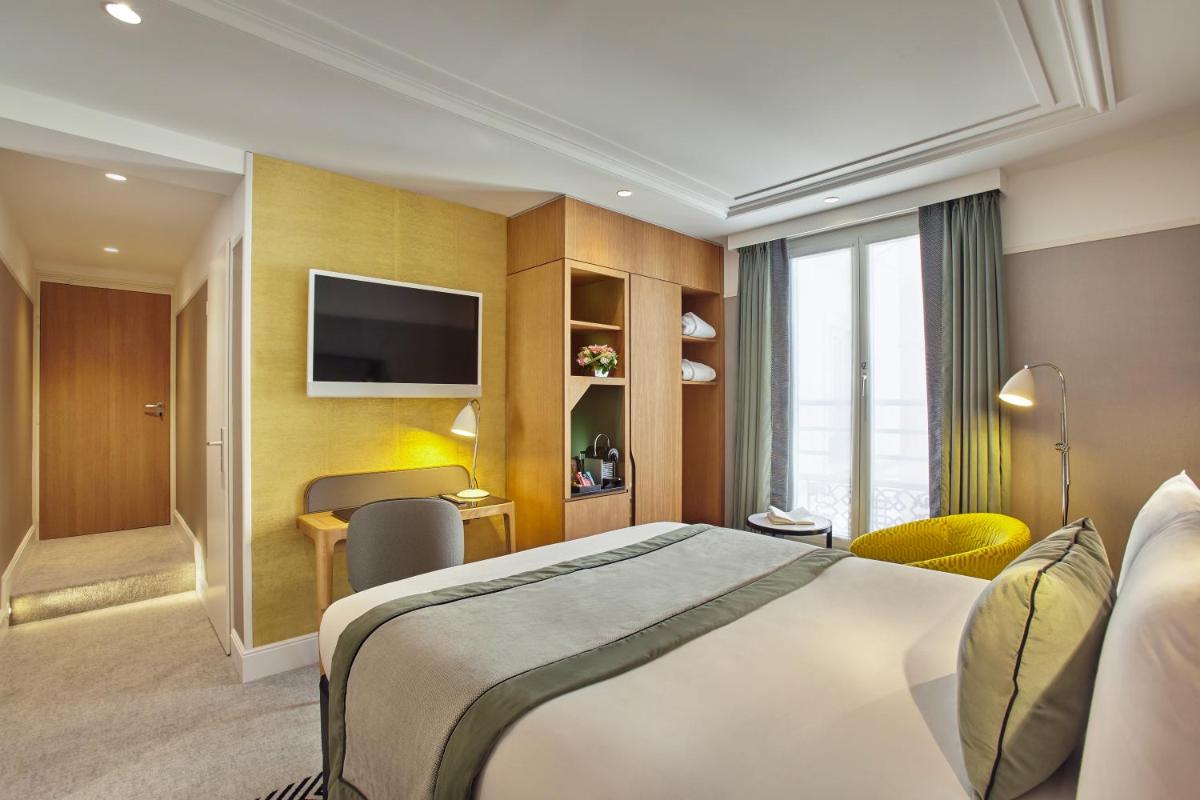 Un ou plusieurs lits dans un hébergement de l'établissement Mercure Paris Opera Garnier Hôtel & Spa