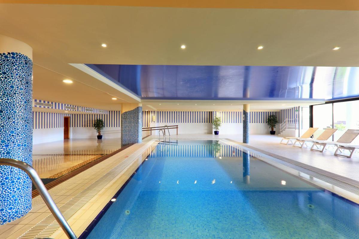 una piscina en un edificio con piscina en Iberostar Waves Málaga Playa, en Torrox Costa