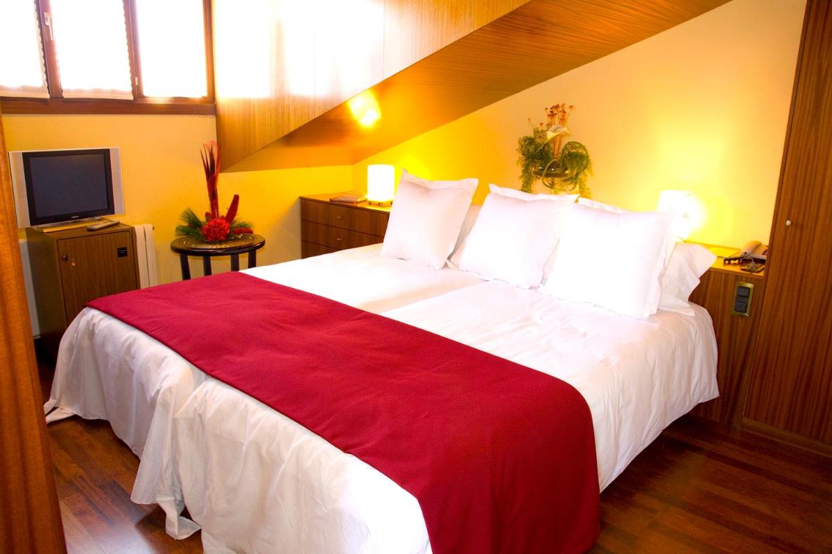 Cama o camas de una habitación en Hotel Del Lago