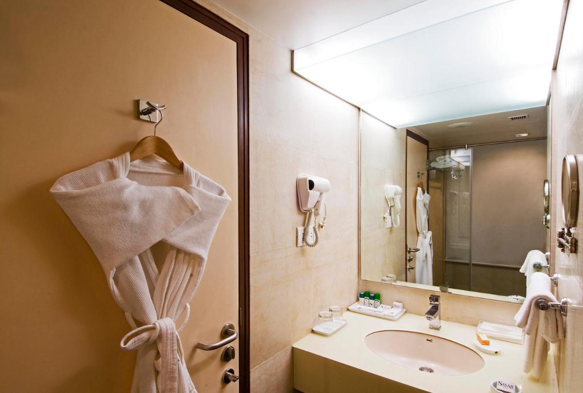 a bathroom with a sink and a mirror at Sayaji Pune in Pune
