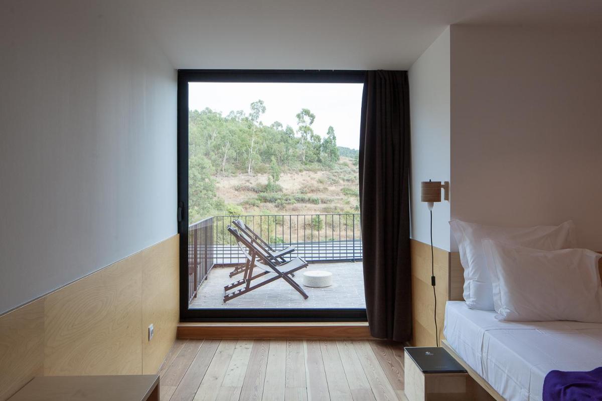 Uma cama ou camas num quarto em Colmeal Countryside Hotel