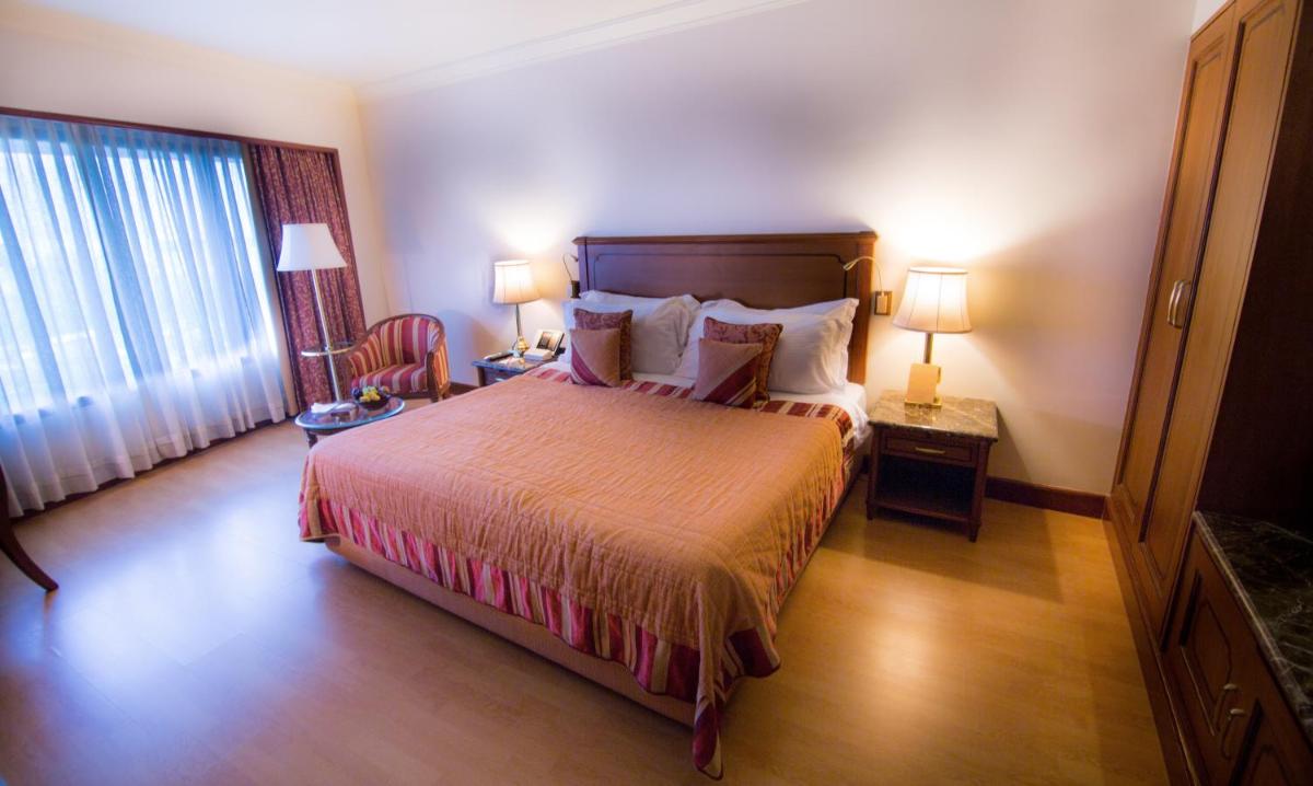 a hotel room with a bed and a window at The Orchid Hotel Mumbai Vile Parle in Mumbai