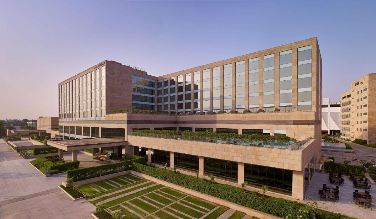 a large building with a lot of plants in front of it at Hyatt Regency Chandigarh in Chandīgarh