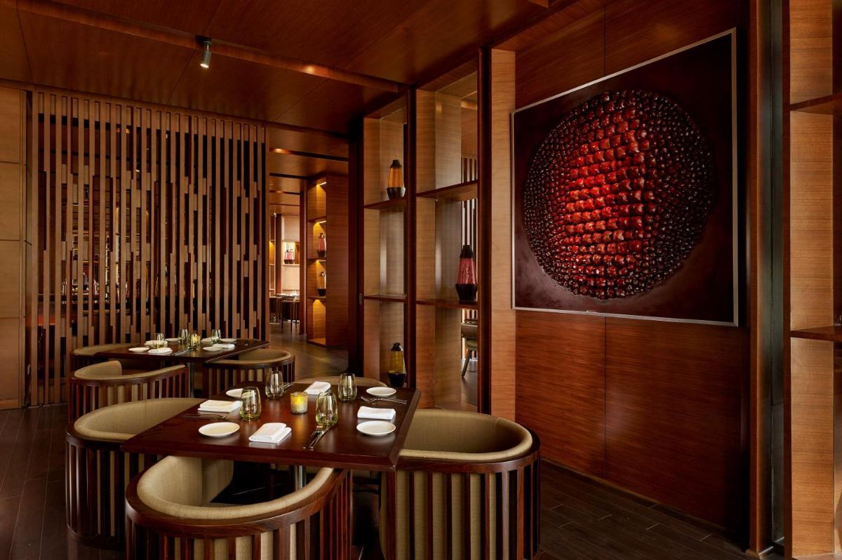 a restaurant with chairs and a table with wine glasses at Hyatt Regency Chandigarh in Chandīgarh