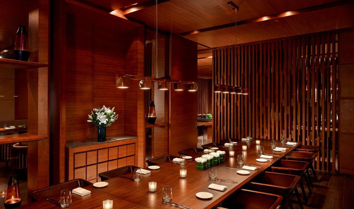 a long dining room with a long table and chairs at Hyatt Regency Chandigarh in Chandīgarh