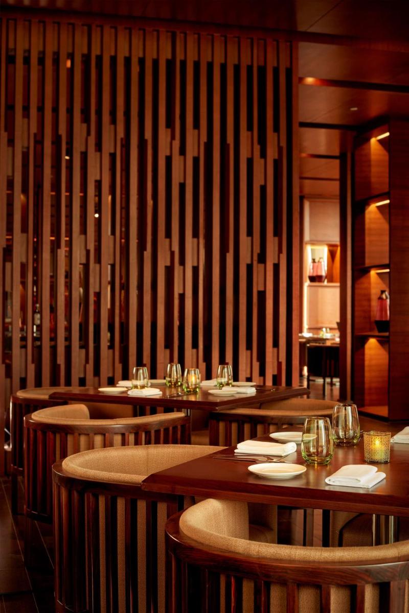 a dining room with wooden tables and chairs at Hyatt Regency Chandigarh in Chandīgarh