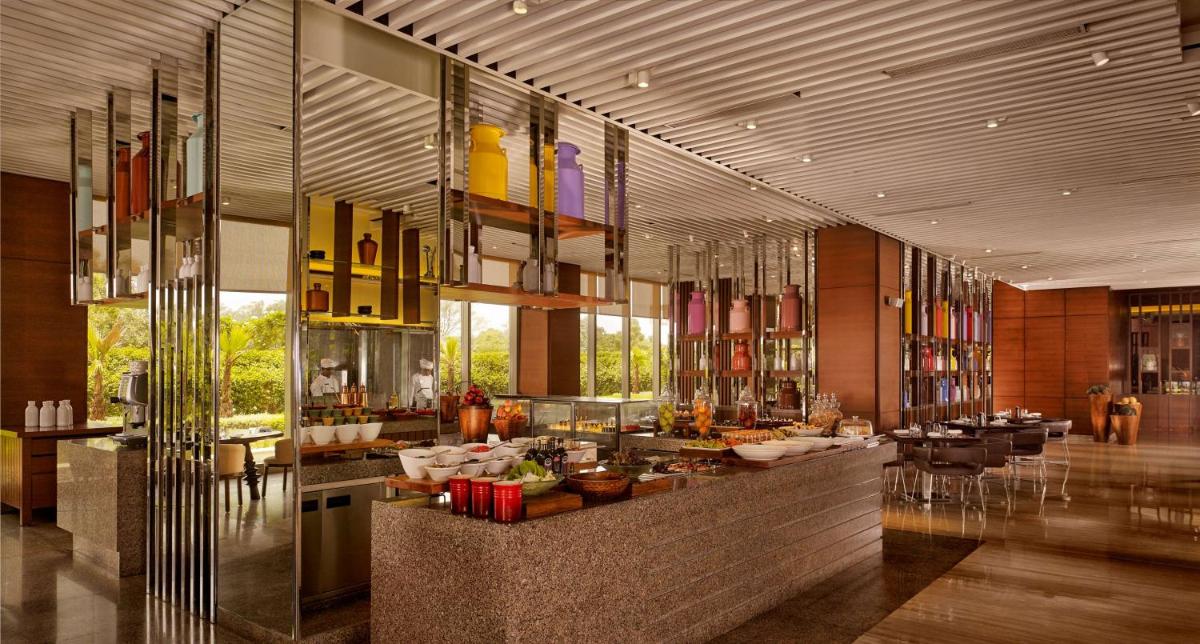 a restaurant with a buffet in the middle of a building at Hyatt Regency Chandigarh in Chandīgarh