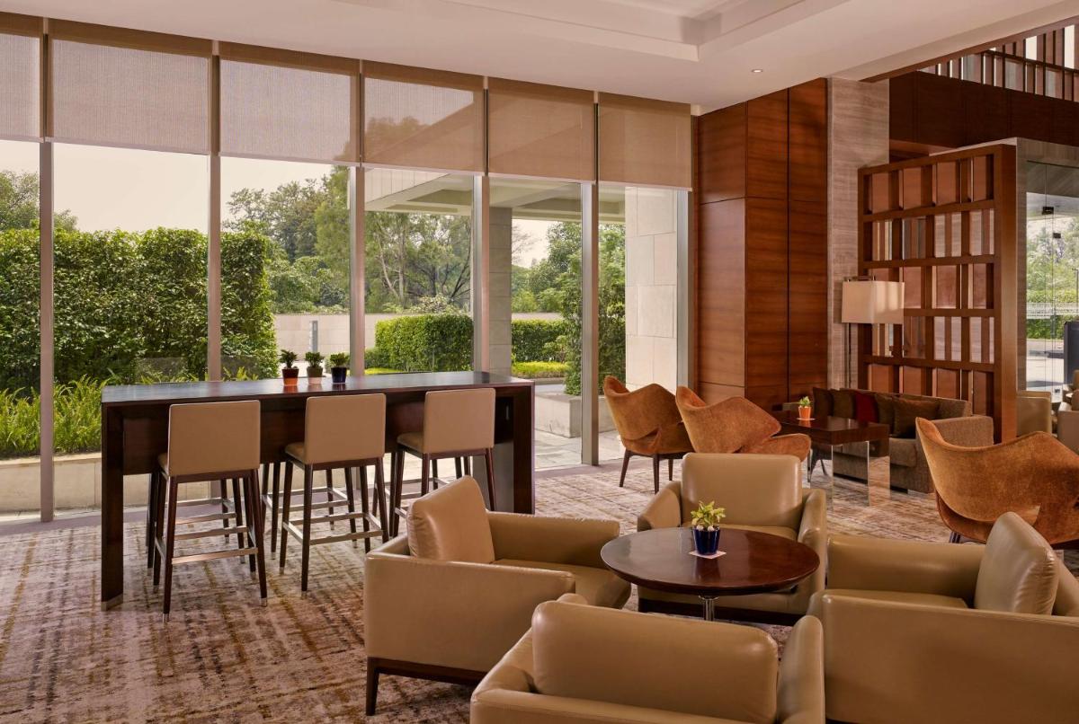 a lobby with a table and chairs at Hyatt Regency Chandigarh in Chandīgarh