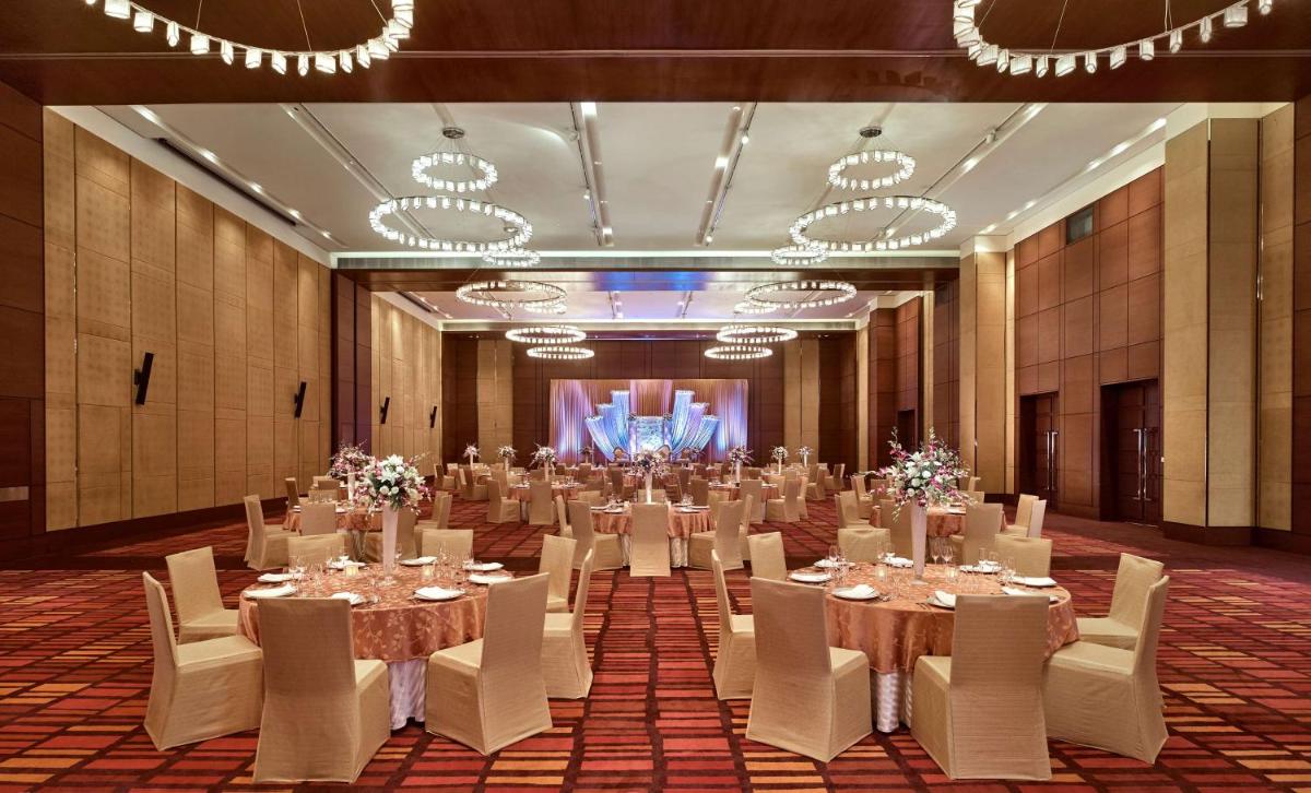 a large banquet hall with tables and white chairs at Hyatt Regency Chandigarh in Chandīgarh