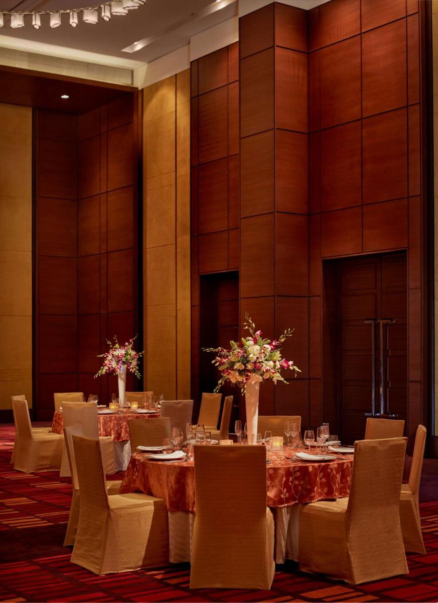 a dining room with a table and chairs at Hyatt Regency Chandigarh in Chandīgarh
