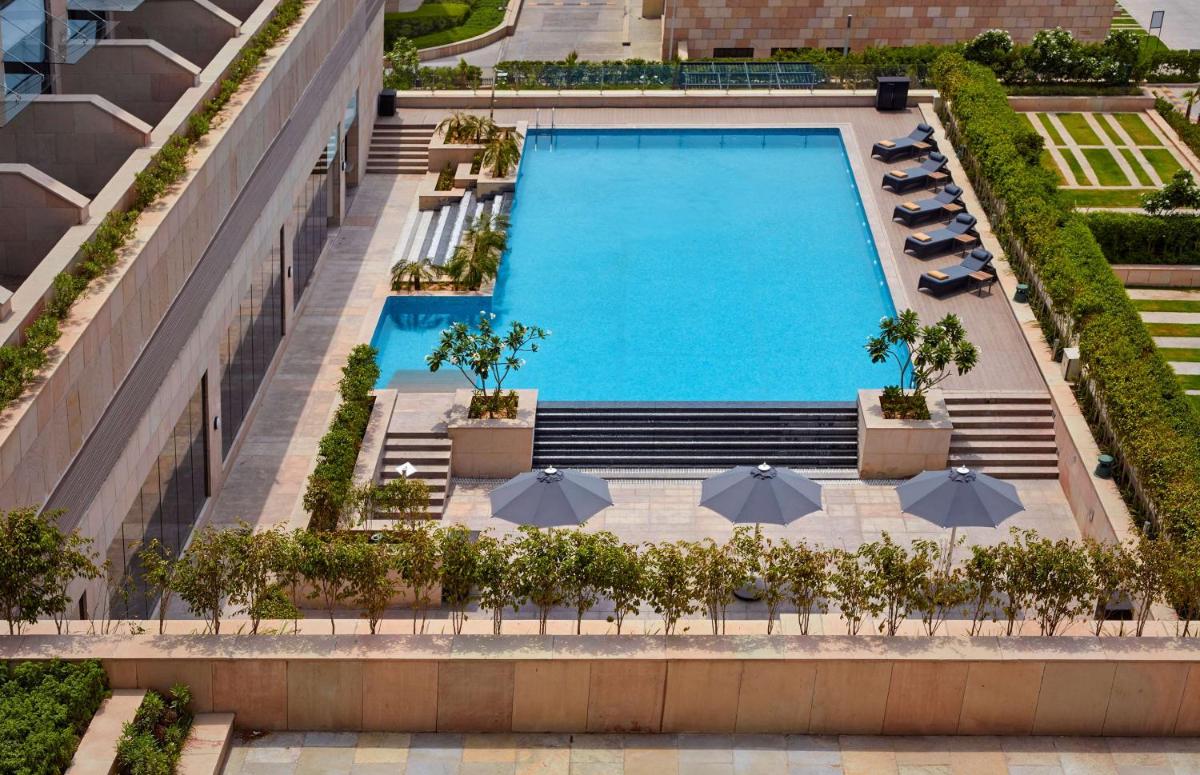 an overhead view of a swimming pool with umbrellas at Hyatt Regency Chandigarh in Chandīgarh