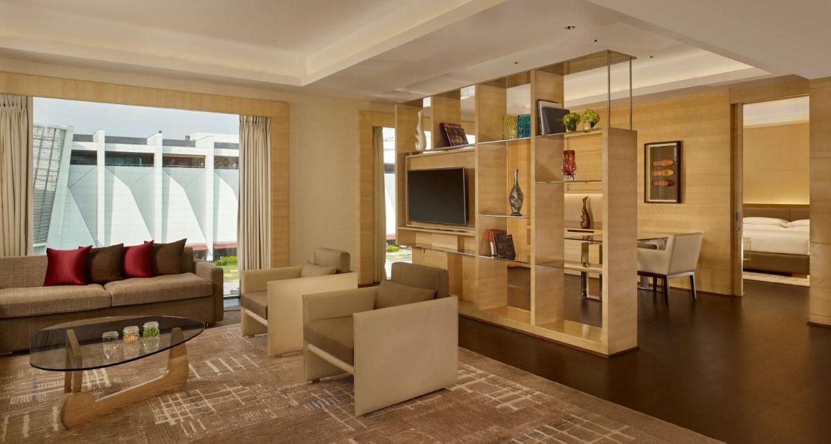 a living room with a couch and a television at Hyatt Regency Chandigarh in Chandīgarh