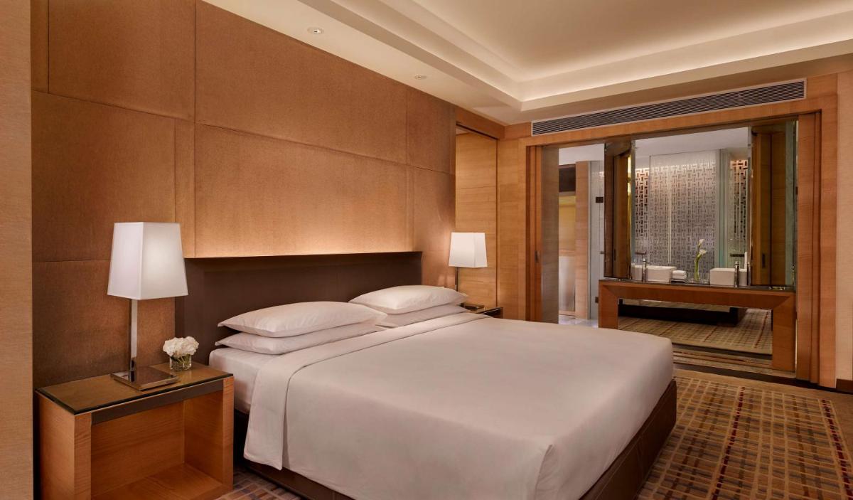 a bedroom with a large white bed in a room at Hyatt Regency Chandigarh in Chandīgarh