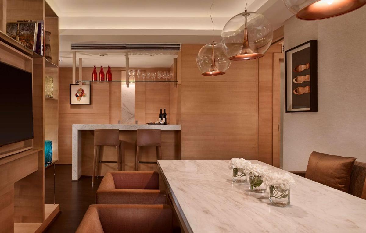 a dining room with a table with wine glasses on it at Hyatt Regency Chandigarh in Chandīgarh