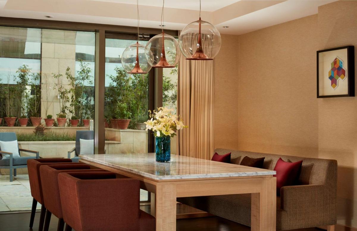 a dining room with a table and chairs at Hyatt Regency Chandigarh in Chandīgarh