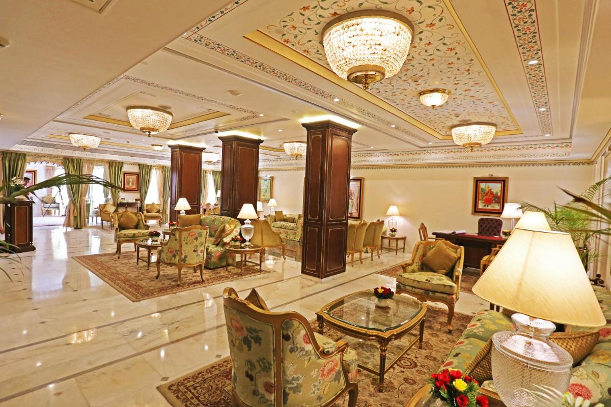 a lobby of a hotel with chairs and tables at Taj Fateh Prakash Palace Udaipur in Udaipur