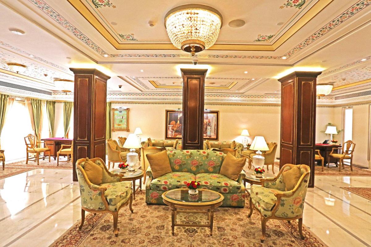 a lobby of a hotel with a couch and chairs at Taj Fateh Prakash Palace Udaipur in Udaipur