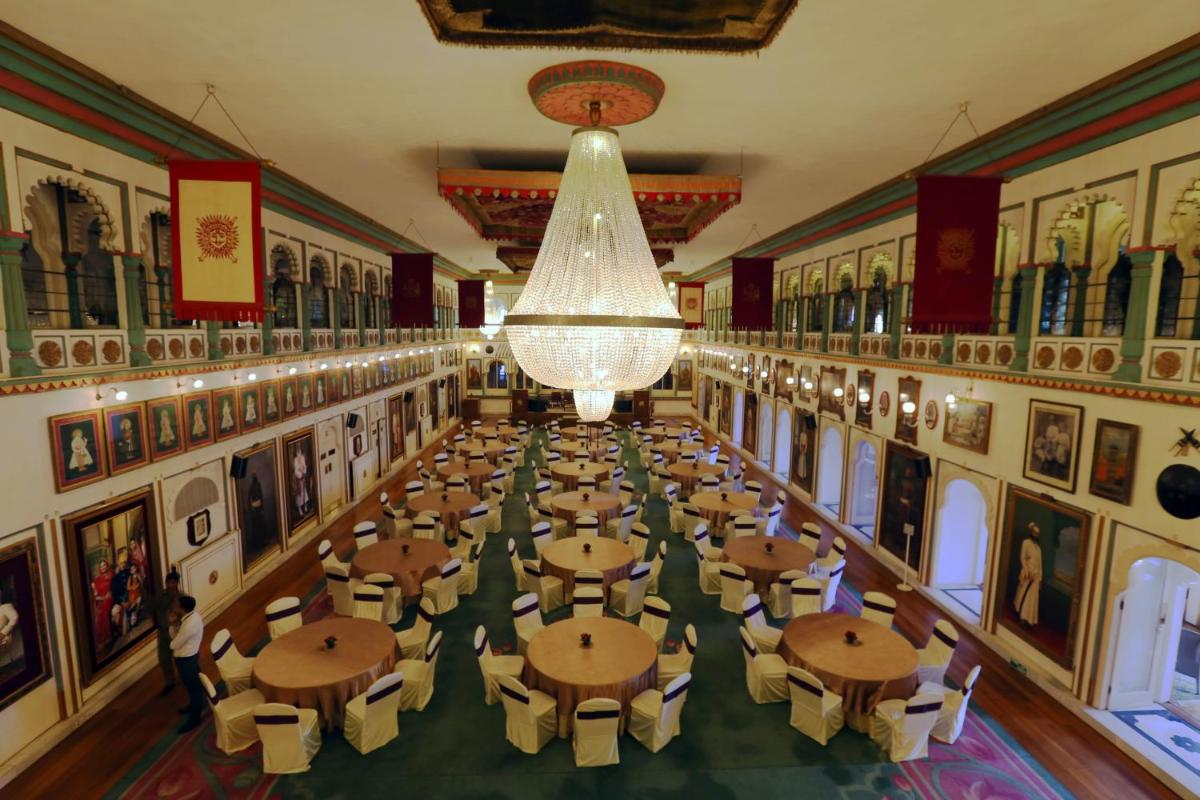 an overhead view of a dining hall with tables and a chandelier at Taj Fateh Prakash Palace Udaipur in Udaipur