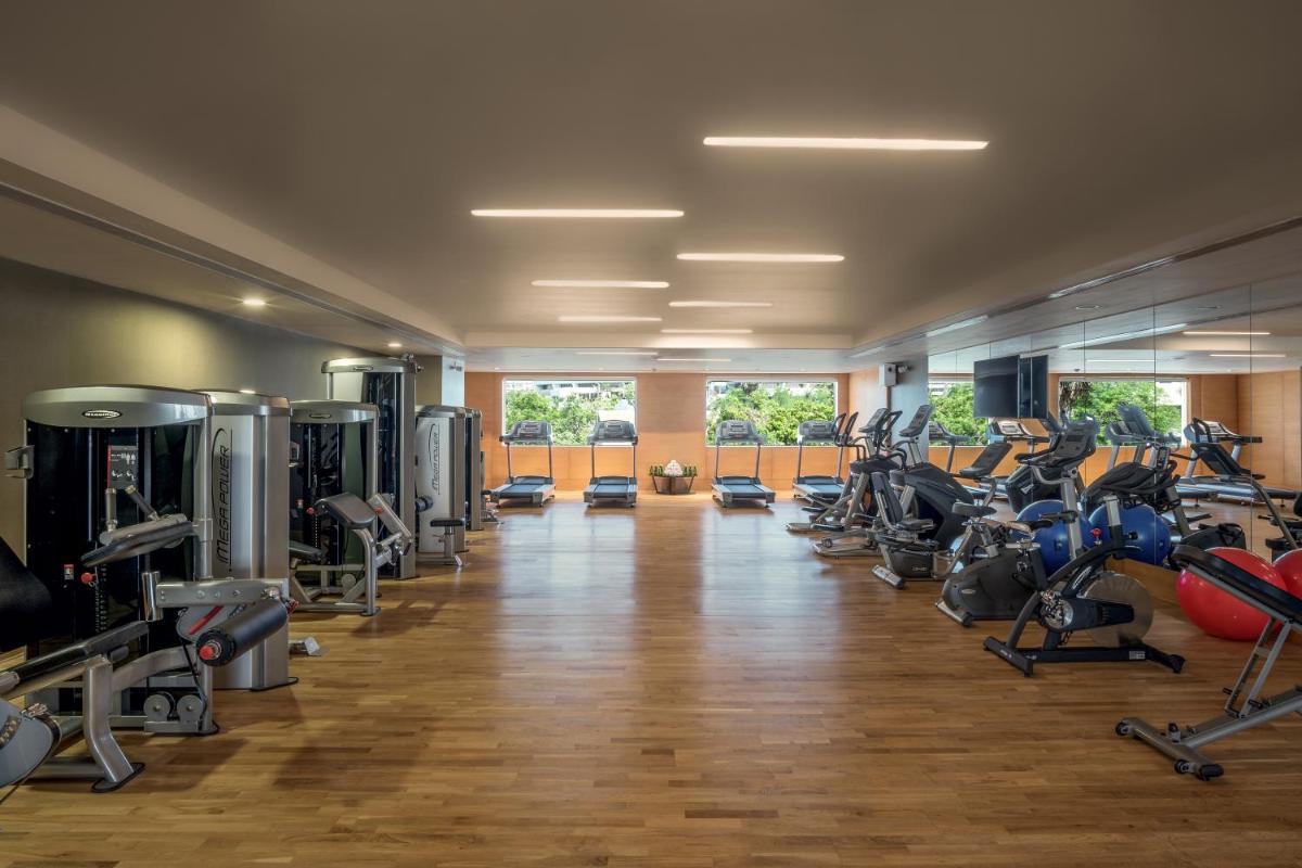 a gym with lots of treadmills and exercise bikes at Feathers- A Radha Hotel, Chennai in Chennai