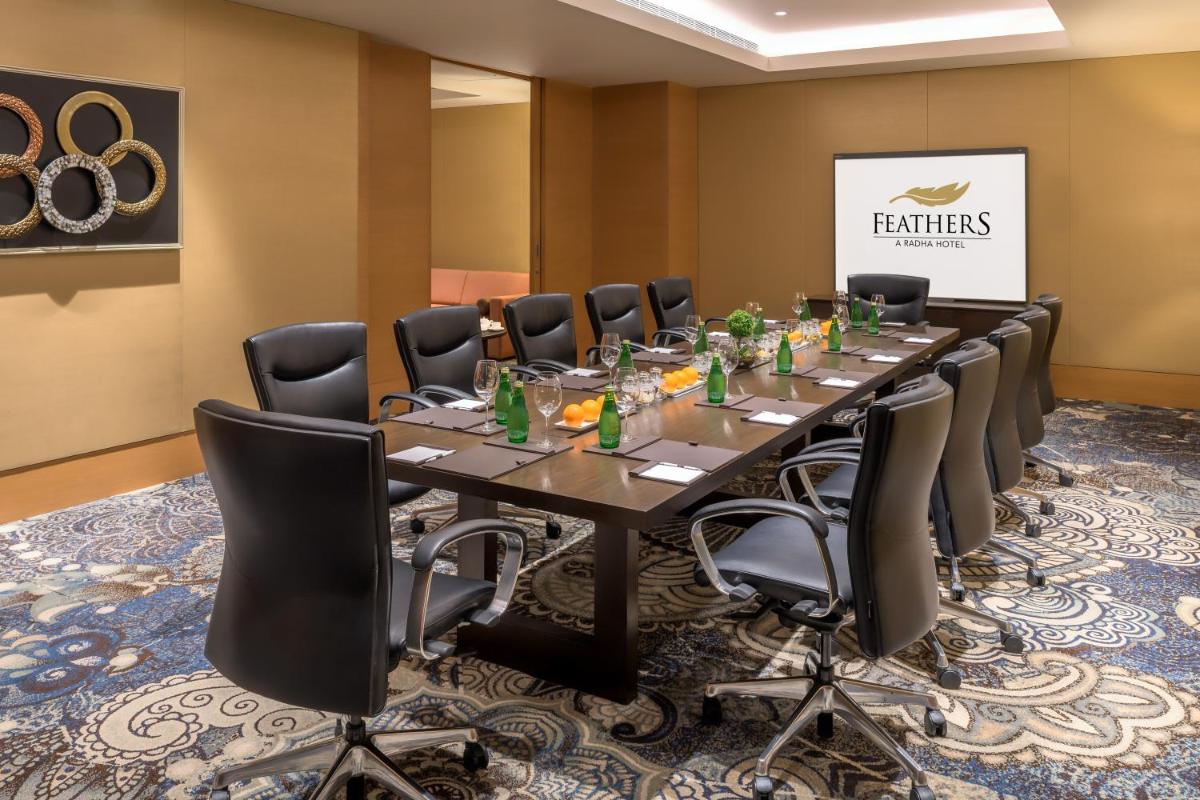 a conference room with a long table and chairs at Feathers- A Radha Hotel, Chennai in Chennai