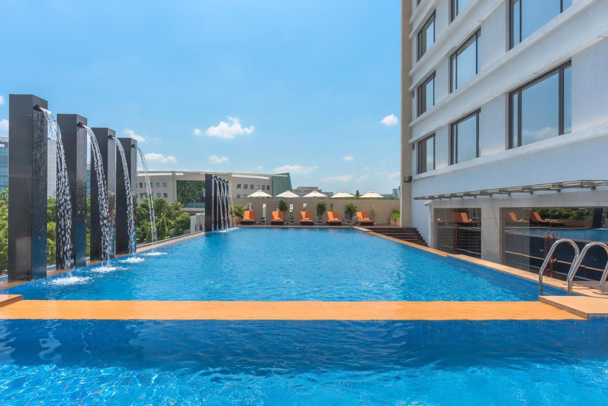 a large swimming pool on the side of a building at Feathers- A Radha Hotel, Chennai in Chennai