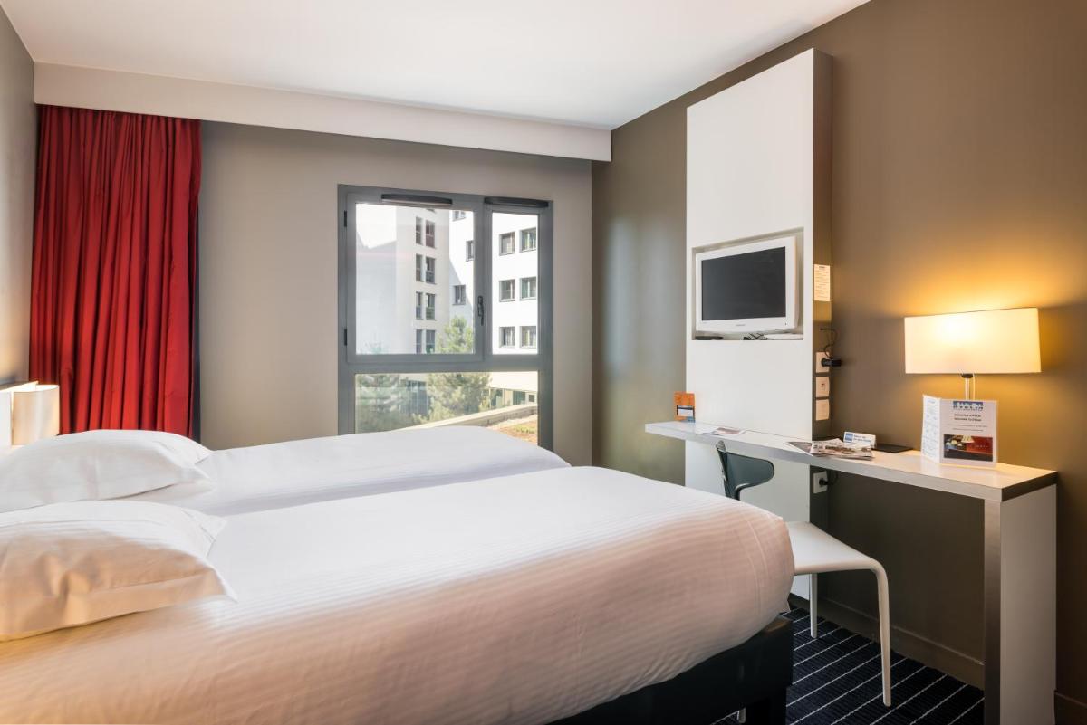 Un ou plusieurs lits dans un hébergement de l'établissement B&B HOME Lyon Centre Berthelot
