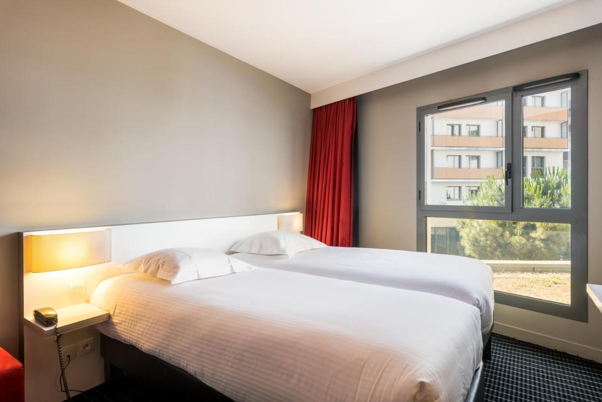 une chambre d'hôtel avec un lit et une fenêtre dans l'établissement B&B HOME Lyon Centre Berthelot, à Lyon
