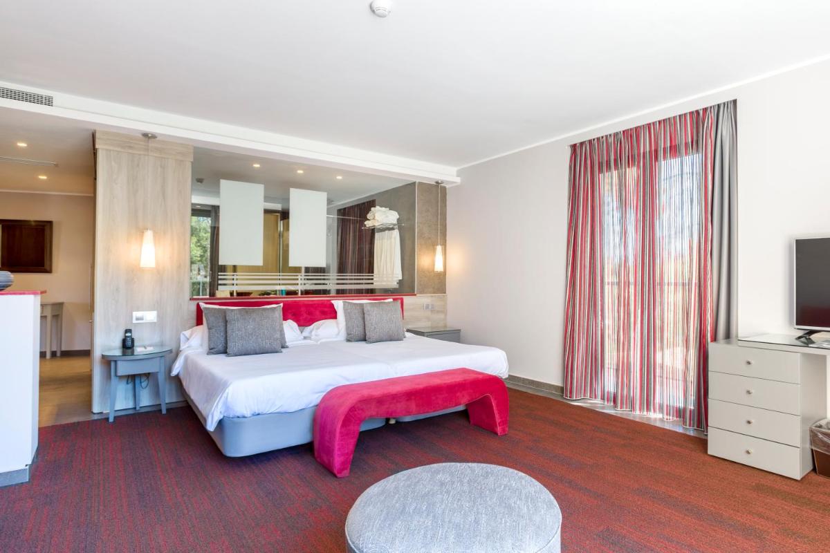 Cama o camas de una habitación en Lago Garden Apart-Suites & Spa Hotel