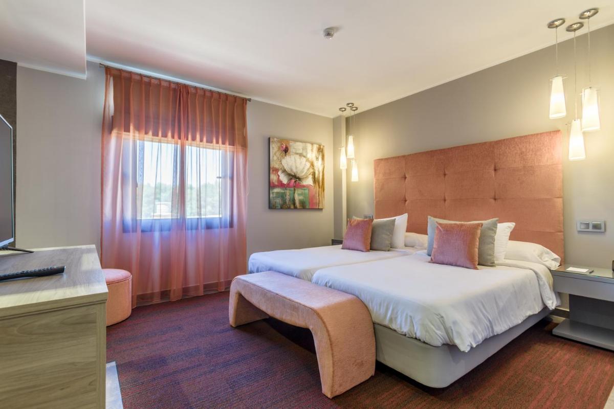 Cama o camas de una habitación en Lago Garden Apart-Suites & Spa Hotel