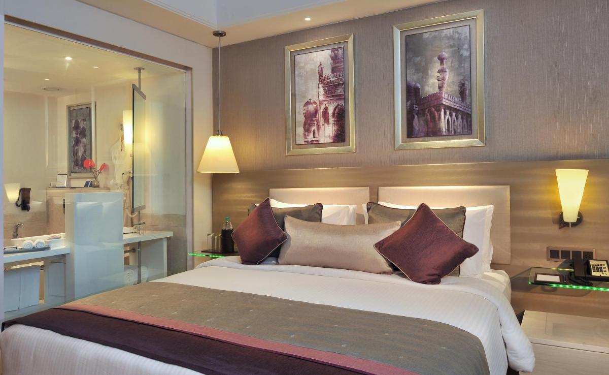 a bedroom with a large white bed with pillows at Radisson Hyderabad Hitec City in Hyderabad