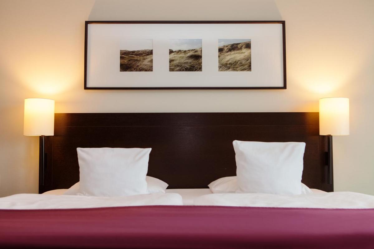 Ein Bett oder Betten in einem Zimmer der Unterkunft A-ROSA Sylt