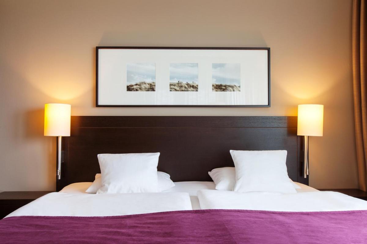 Ein Bett oder Betten in einem Zimmer der Unterkunft A-ROSA Sylt