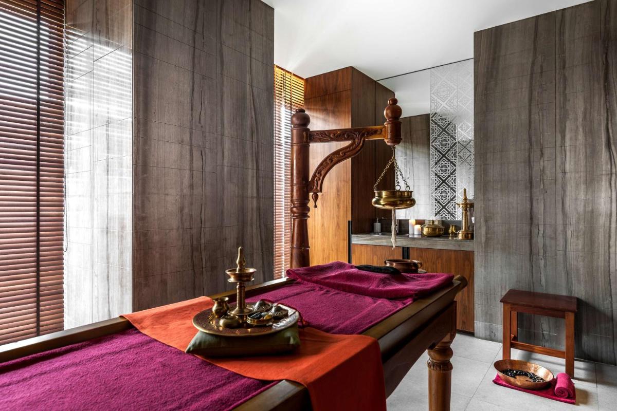 a bedroom with a bed with a purple blanket at Hyatt Ahmedabad in Ahmedabad