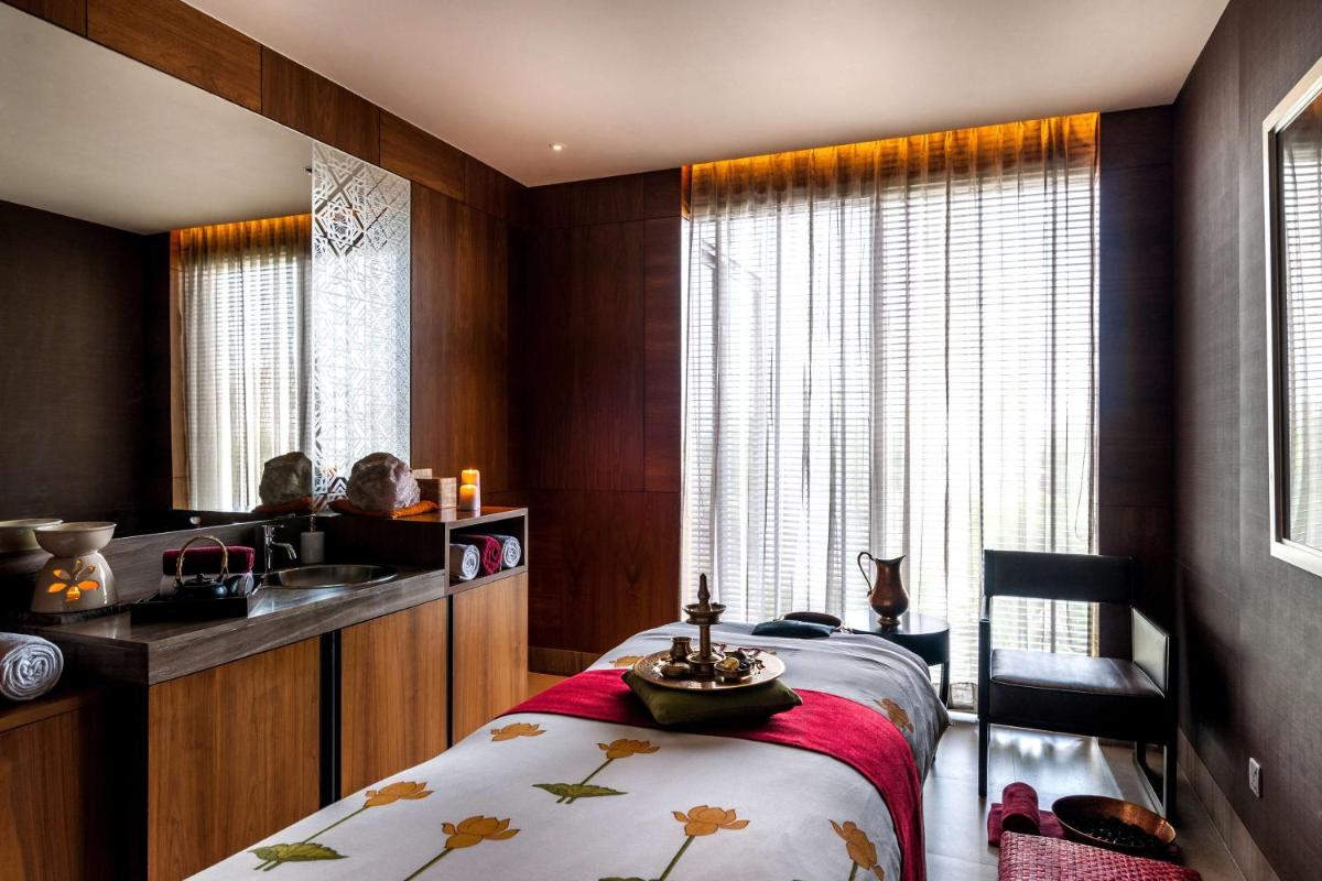 a bedroom with a bed and a sink and a window at Hyatt Ahmedabad in Ahmedabad