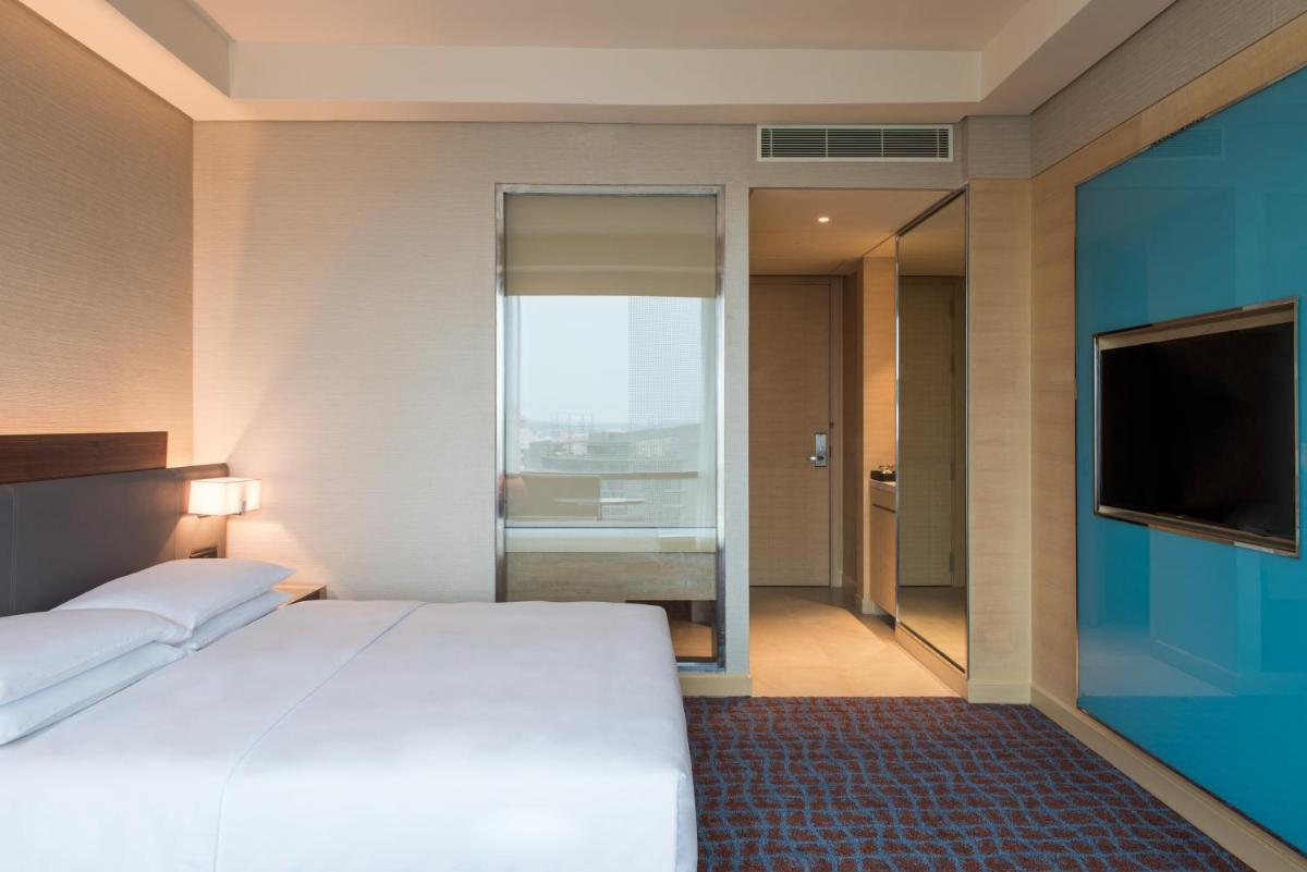 a hotel room with a bed and a television at Hyatt Regency Lucknow Gomti Nagar in Lucknow