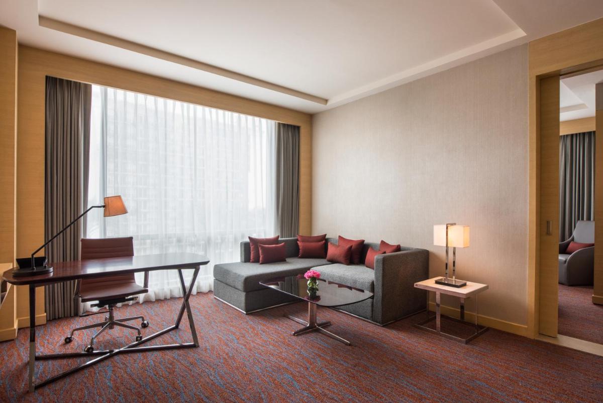 a living room with a couch and a table at Hyatt Regency Lucknow Gomti Nagar in Lucknow