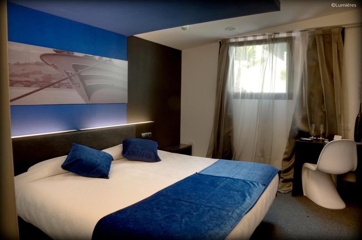 Cama o camas de una habitación en Hotel Playa Ribera