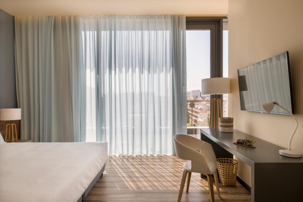 Uma cama ou camas num quarto em The Prime Energize Hotel & SPA - Algarve