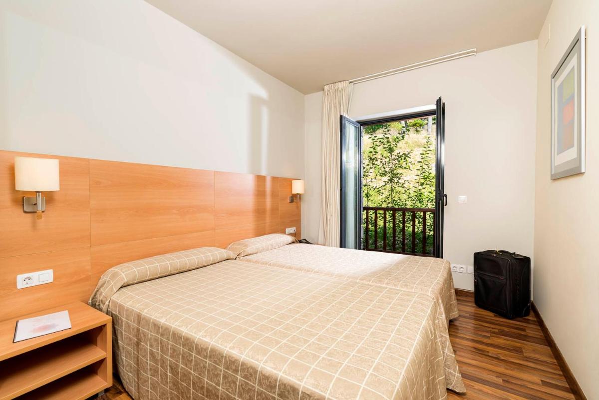 Cama o camas de una habitación en Guitart La Molina Aparthotel & Spa