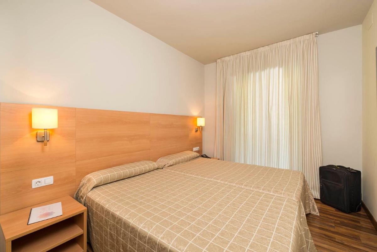 Cama o camas de una habitación en Guitart La Molina Aparthotel & Spa
